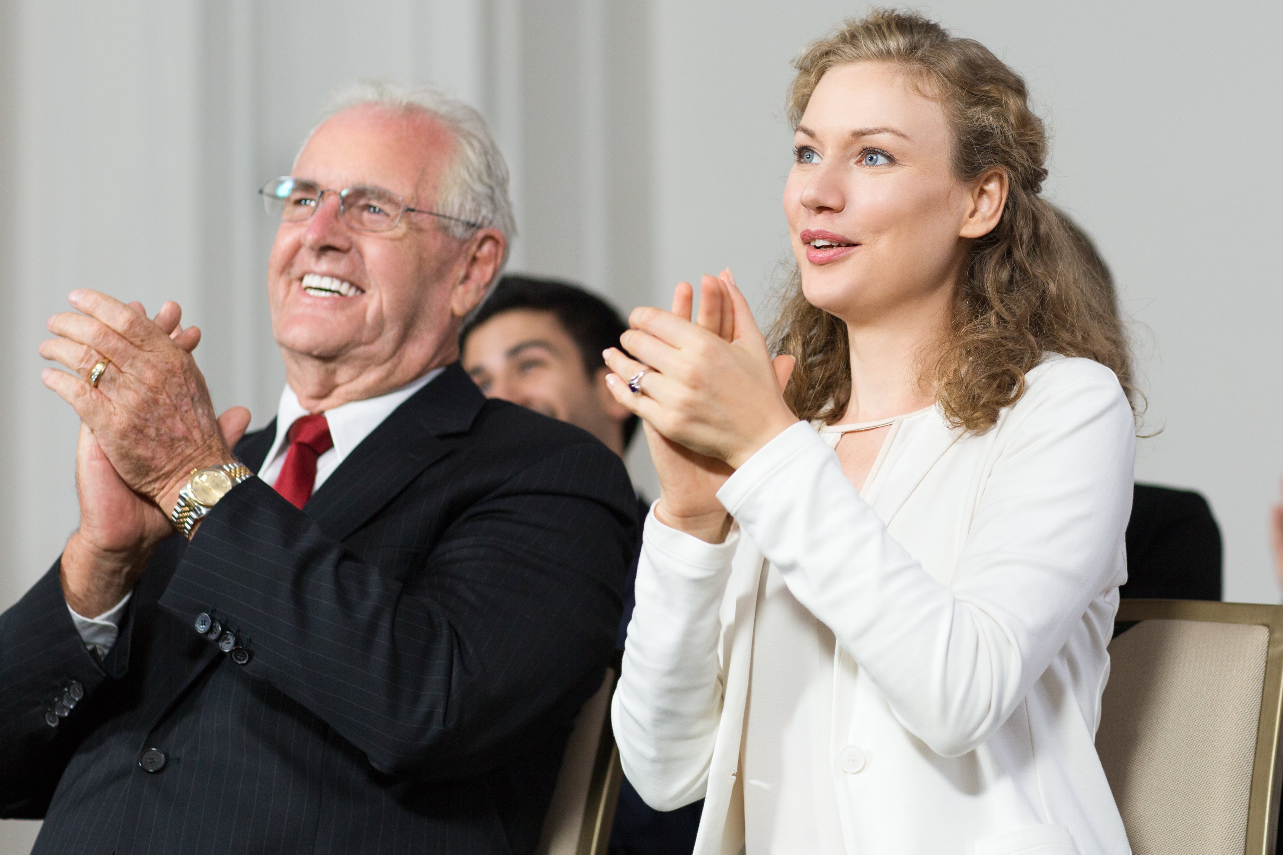 senior business man clapping with woman