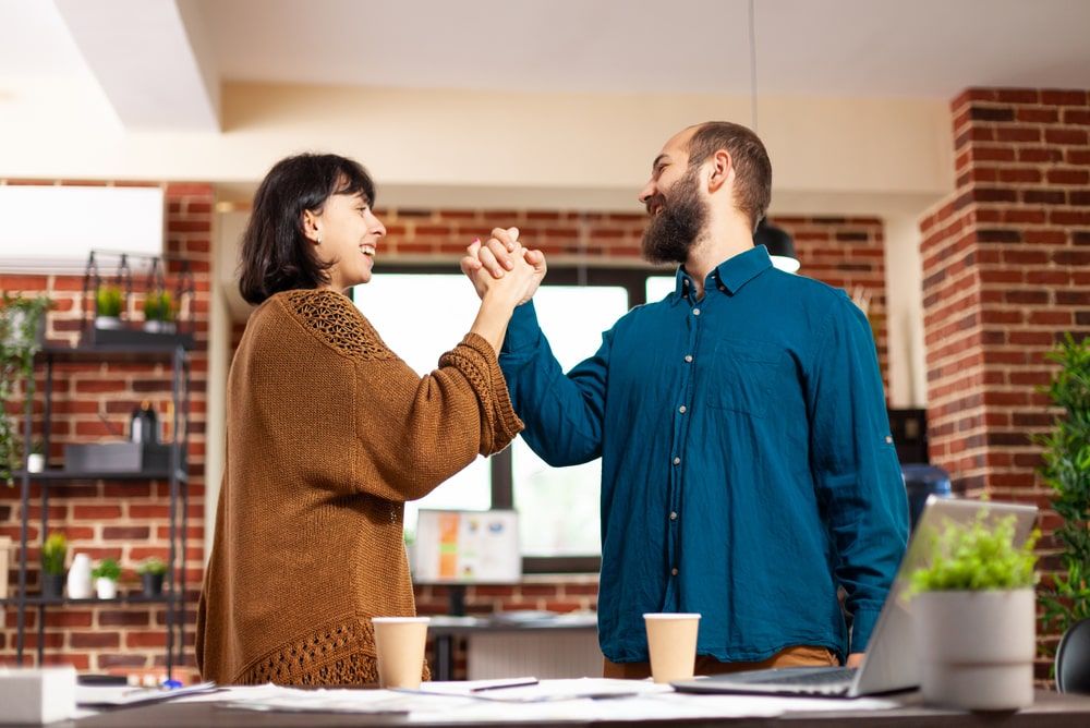 manager and employee celebrating - Employee Retention