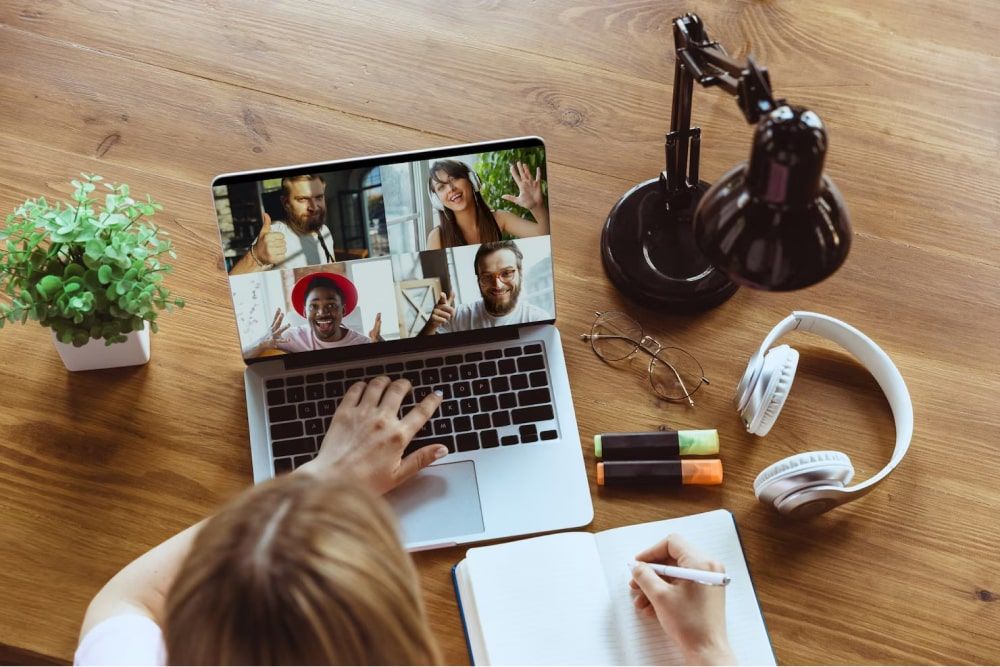 woman taking notes of the meeting - Holiday Gifts For Remote Employees