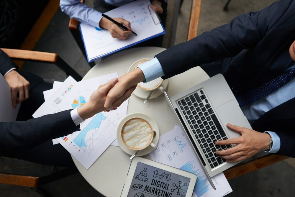 employees shaking hand - Causes Of Staff Turnover