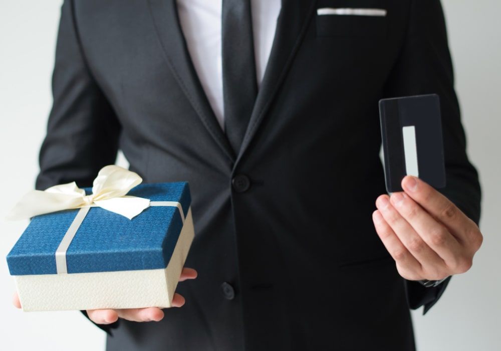 employee holding brand gift - Work Anniversary Gifts