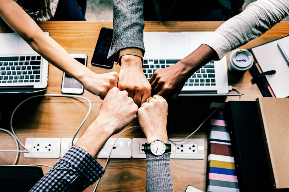 colleagues giving a friendly fist bump in the office